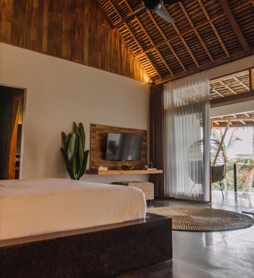 Neano Escape Hotel Manggis Kültér fotó A bedroom at the resort